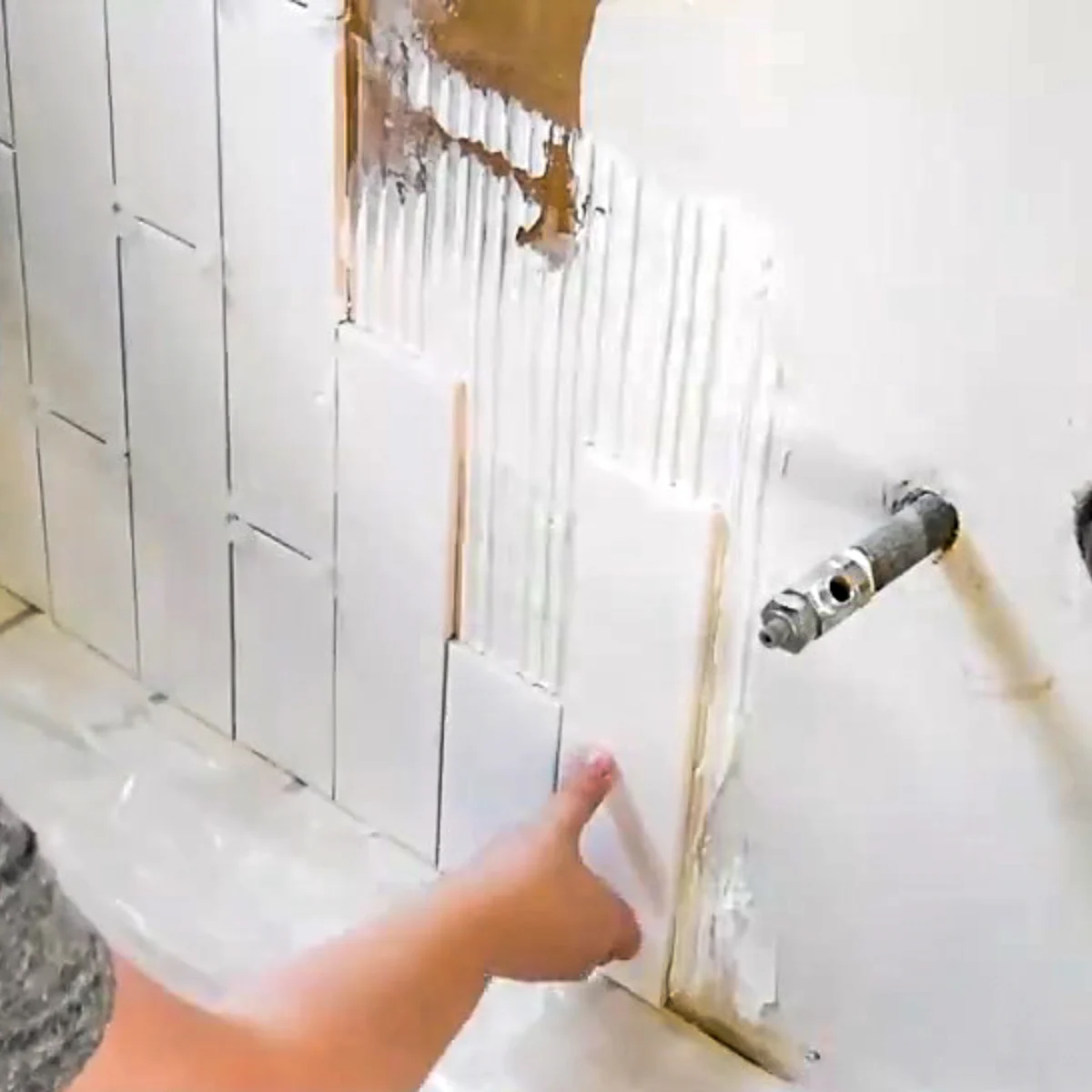 installing the bottom row of vertical subway tile