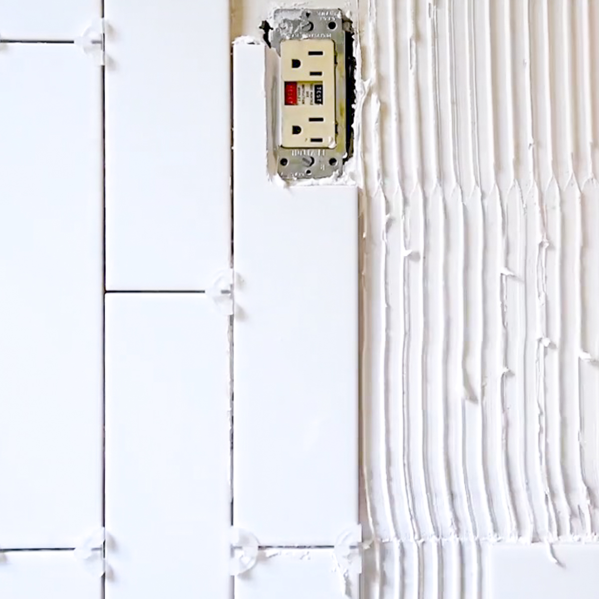 installing subway tile around outlet