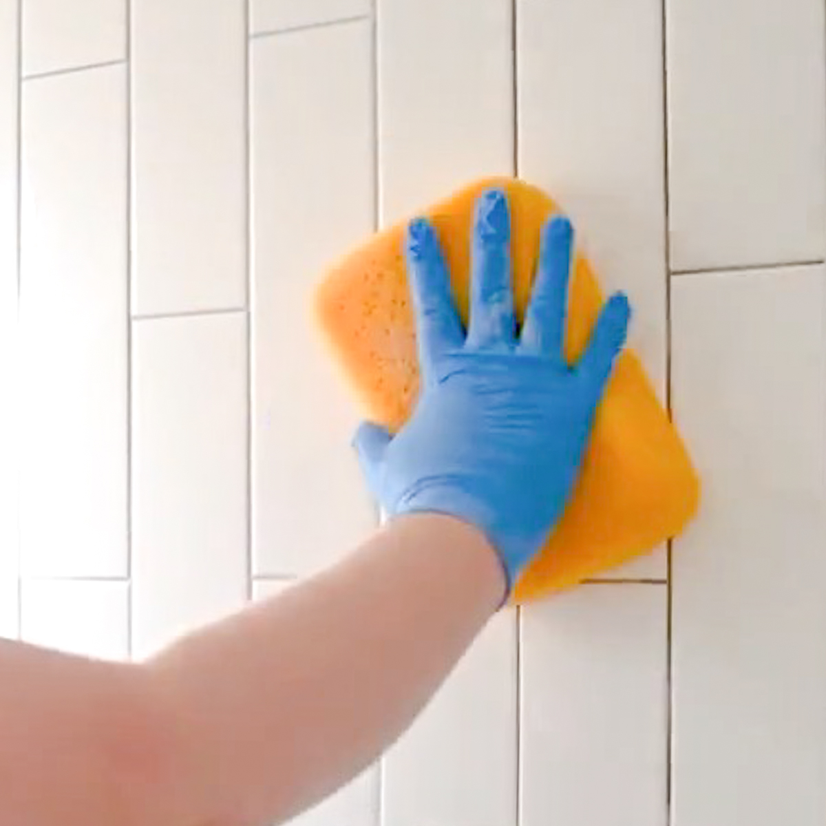 wiping grout with a sponge