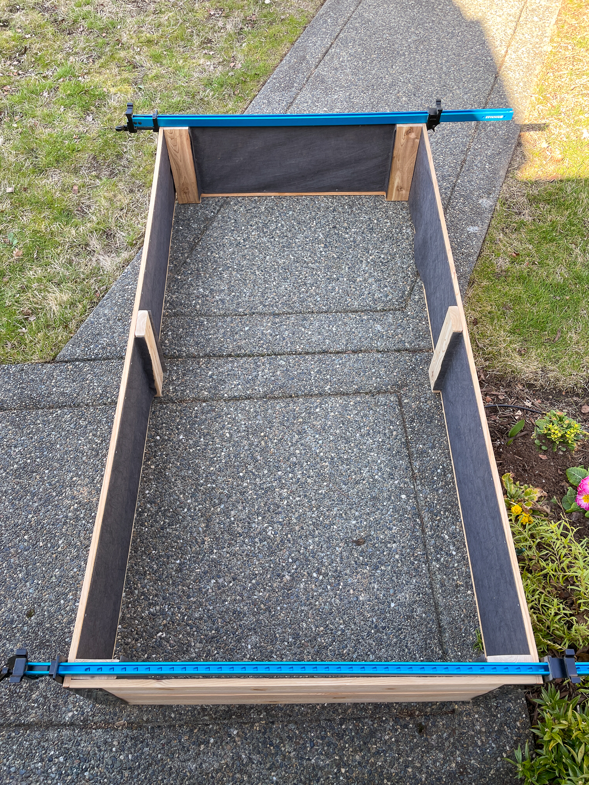 DIY raised garden bed held together with long clamps