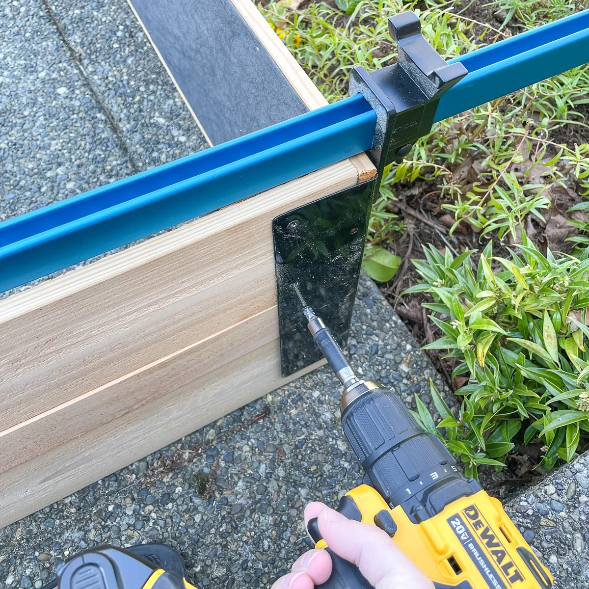 screwing corner bracket to raised garden bed