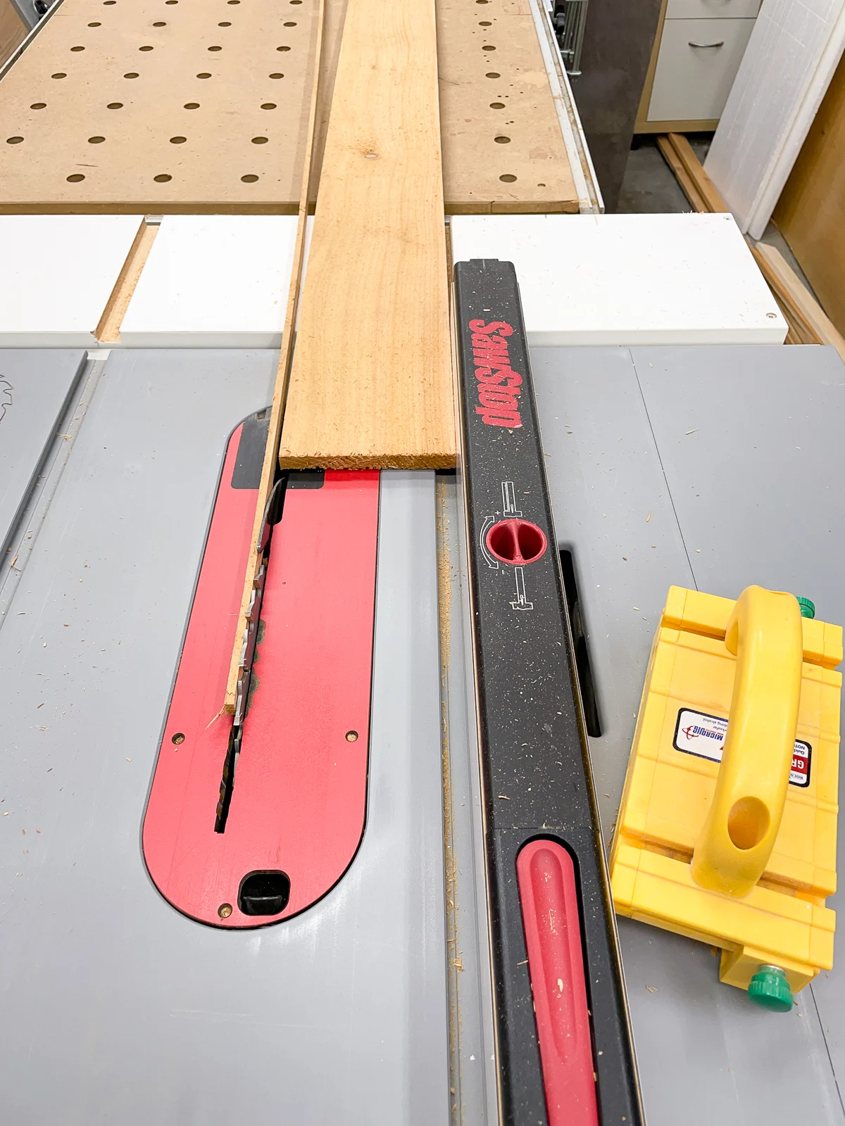 ripping the rough edges off cedar fence pickets at the table saw