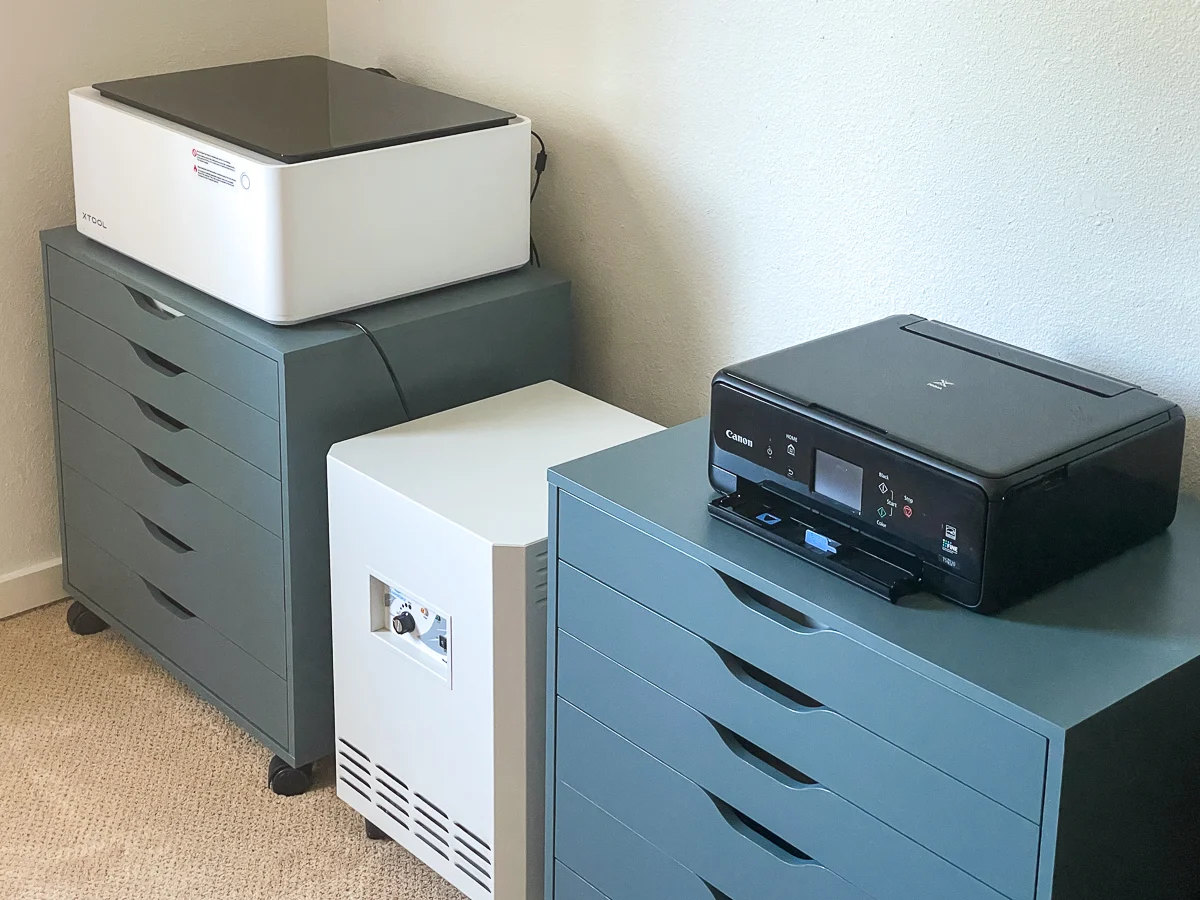 xTool M1 laser cutter next to printer and air purifier