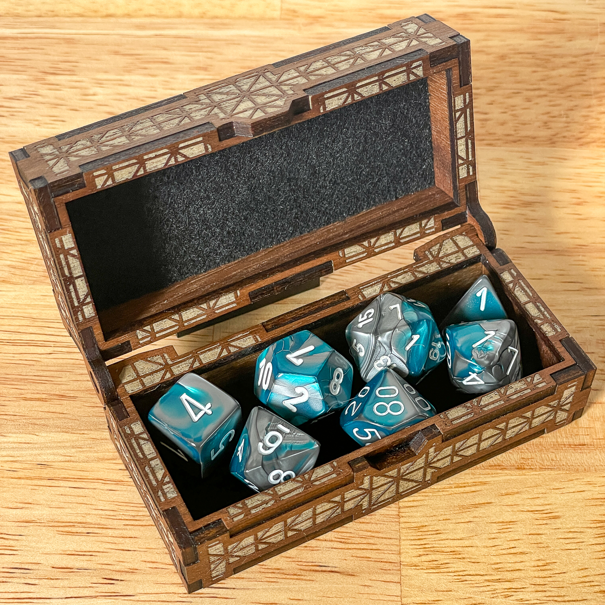 DIY dice box with blue and gray dungeons and dragons dice set inside
