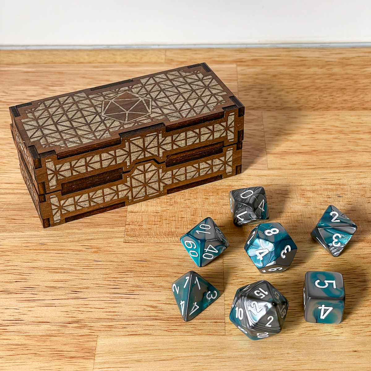 closed DIY dice box with dice on the table beside it