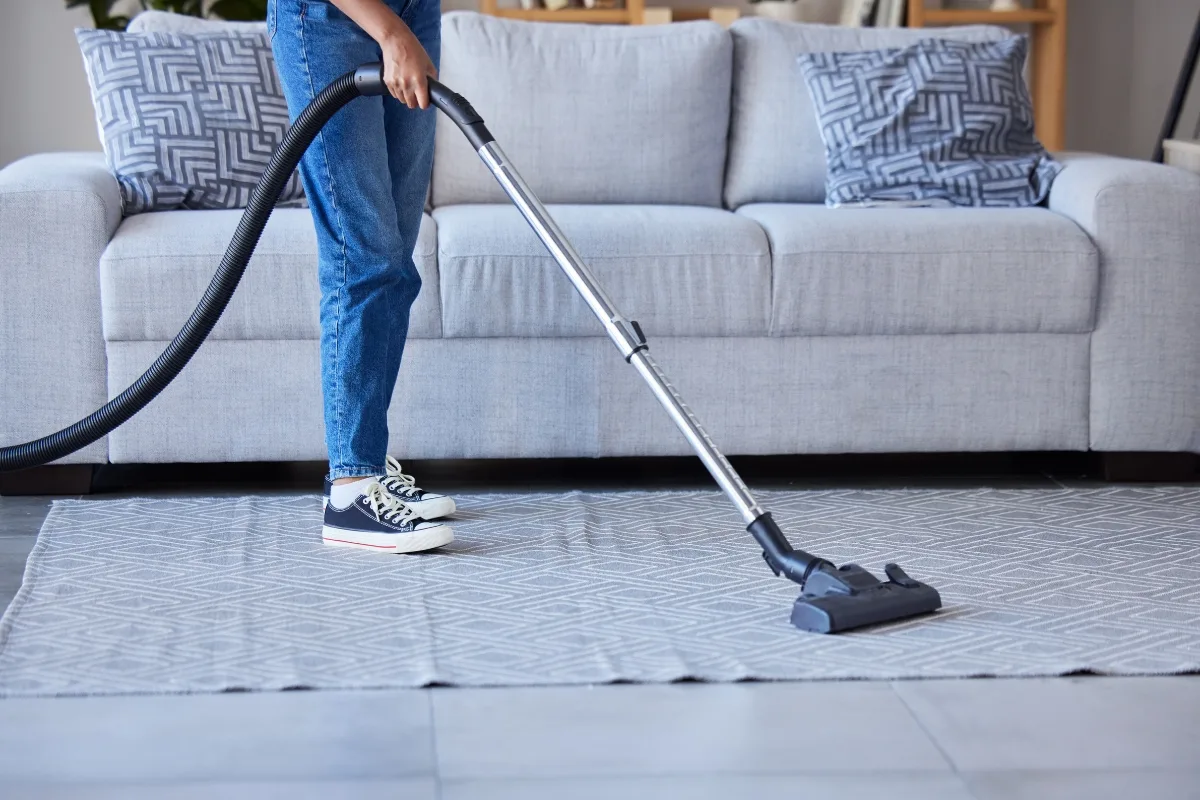 vacuuming an area rug