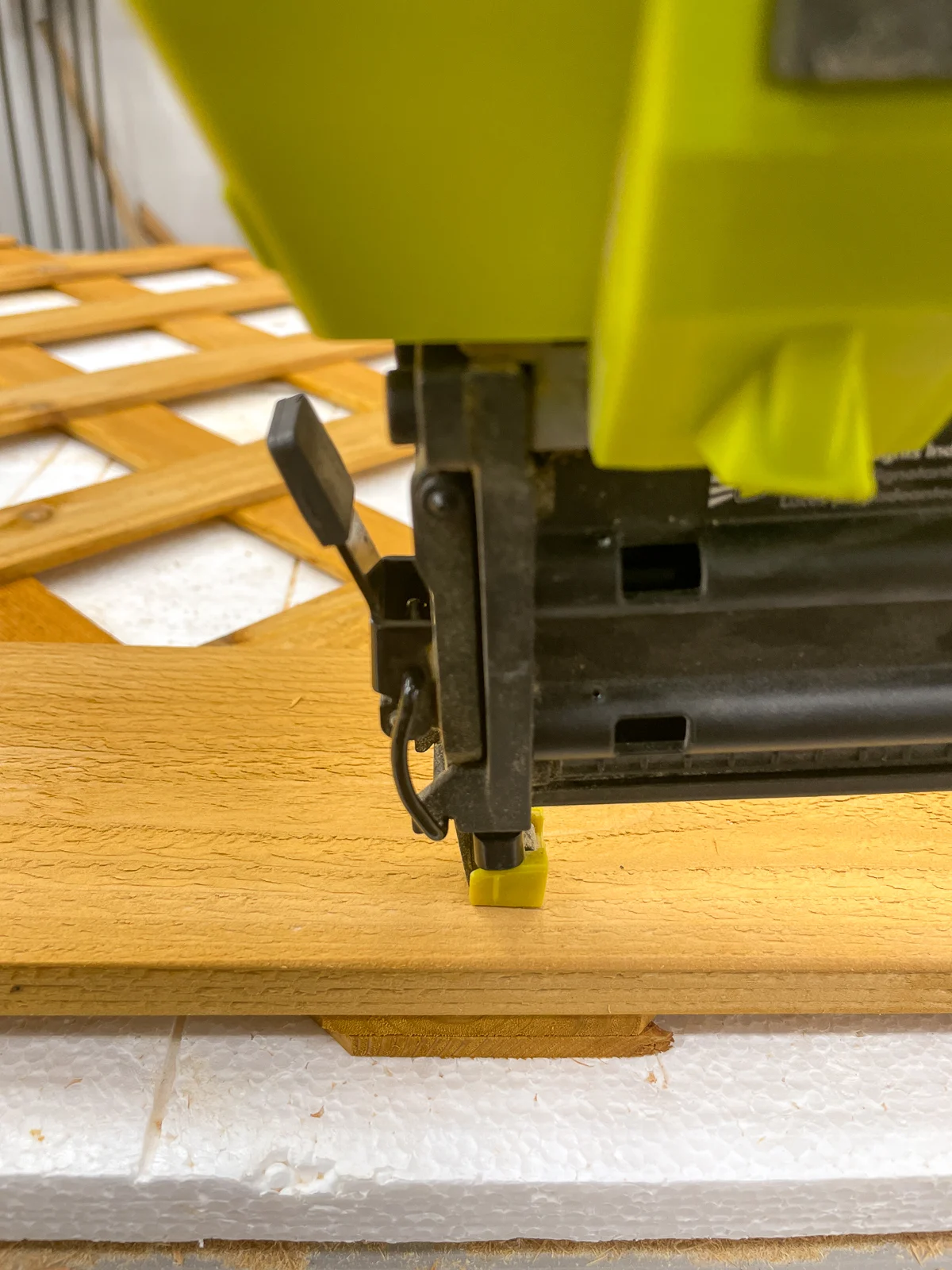 attaching the front piece of trim to the top of the lattice with a brad nailer