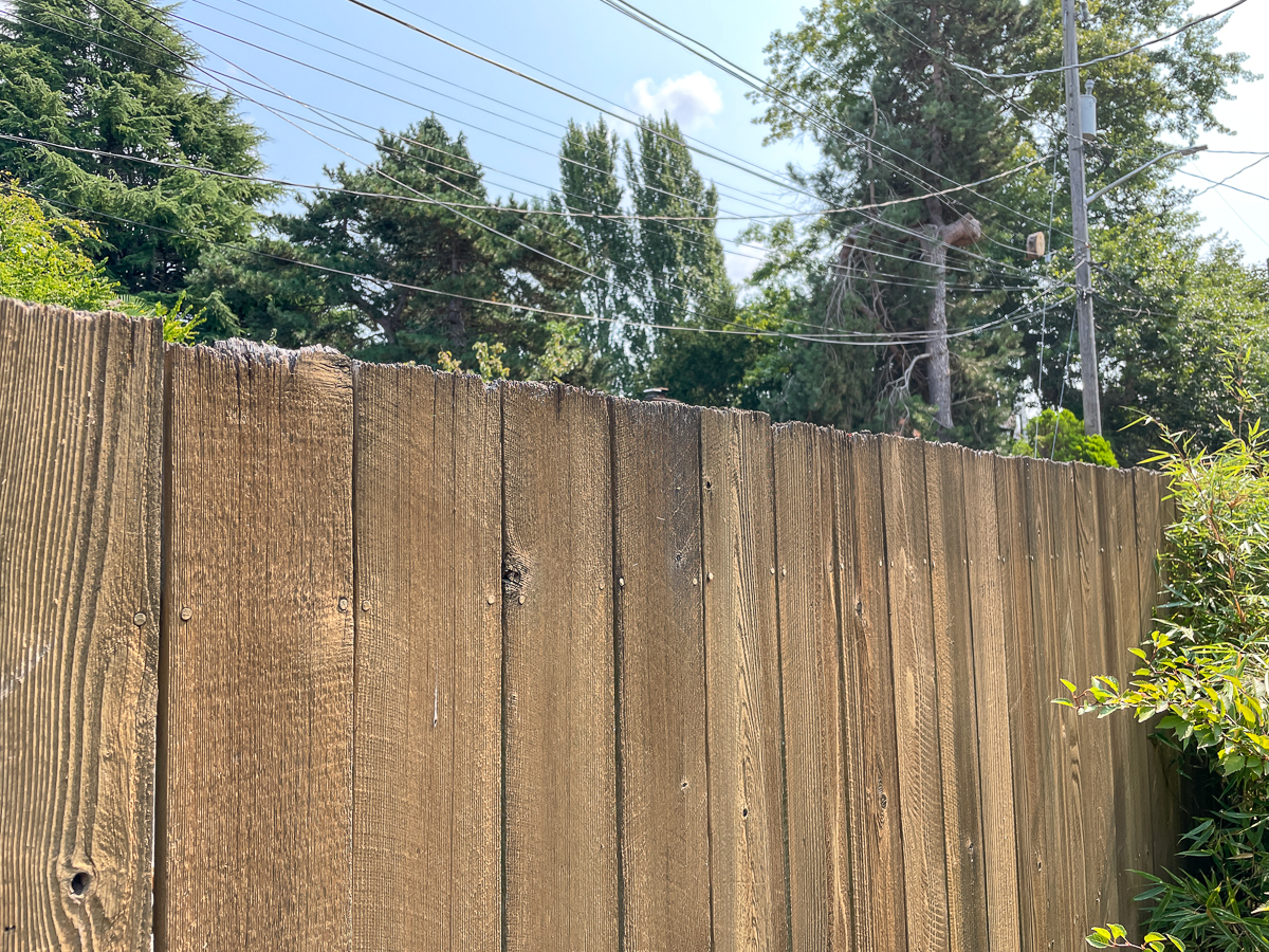 front view of fence with worn picket tops