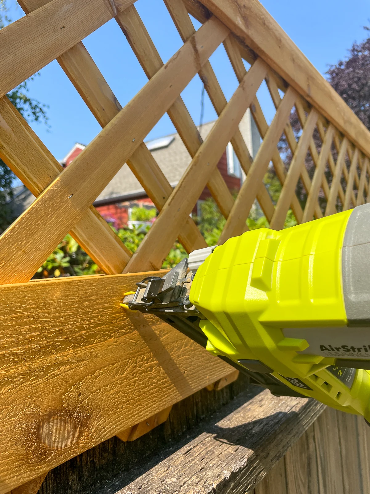 nailing wide trim board to the back of the fence top trellis