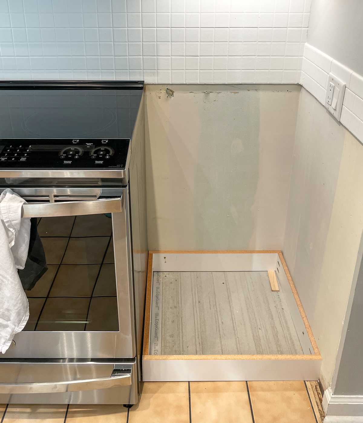 removed cabinet to expose bottom edge of old backsplash tile to be removed