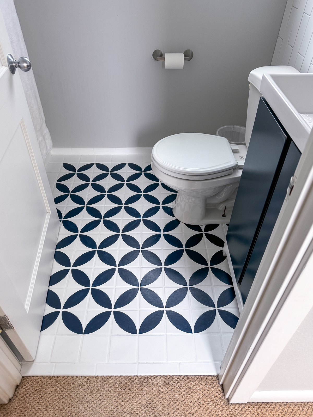 powder room with painted tile floor