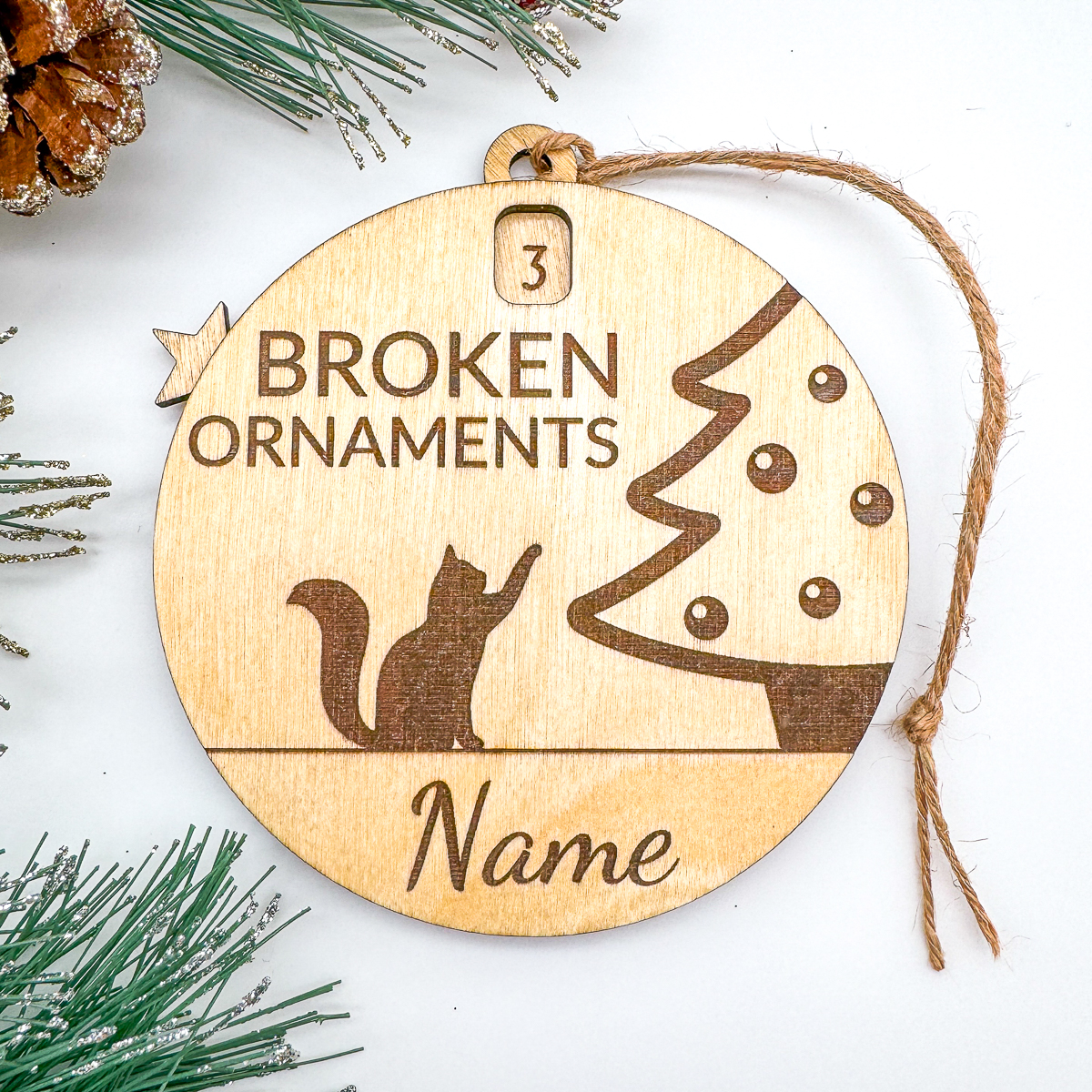 engraved version of a laser cut Christmas ornament with counter of the number of ornaments the cat has broken over the holiday season