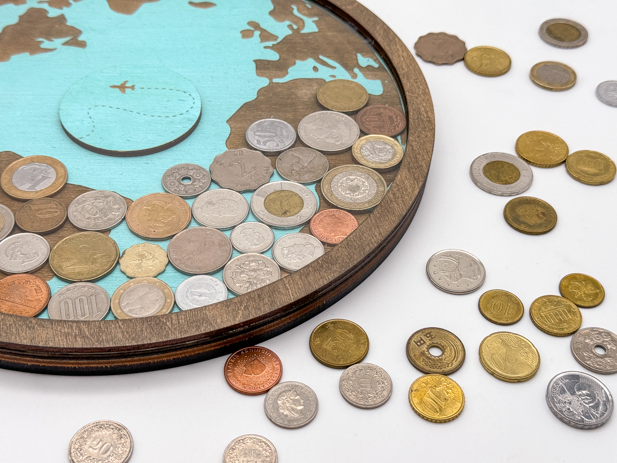 DIY coin holder with coins from different countries inside and on the table