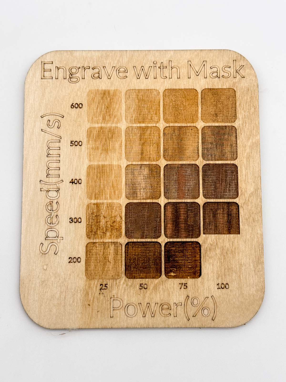 laser test grid for engrave speed and power with mask over wood