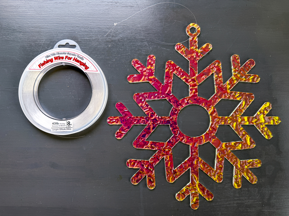 DIY outdoor snowflake decoration with fishing line loop