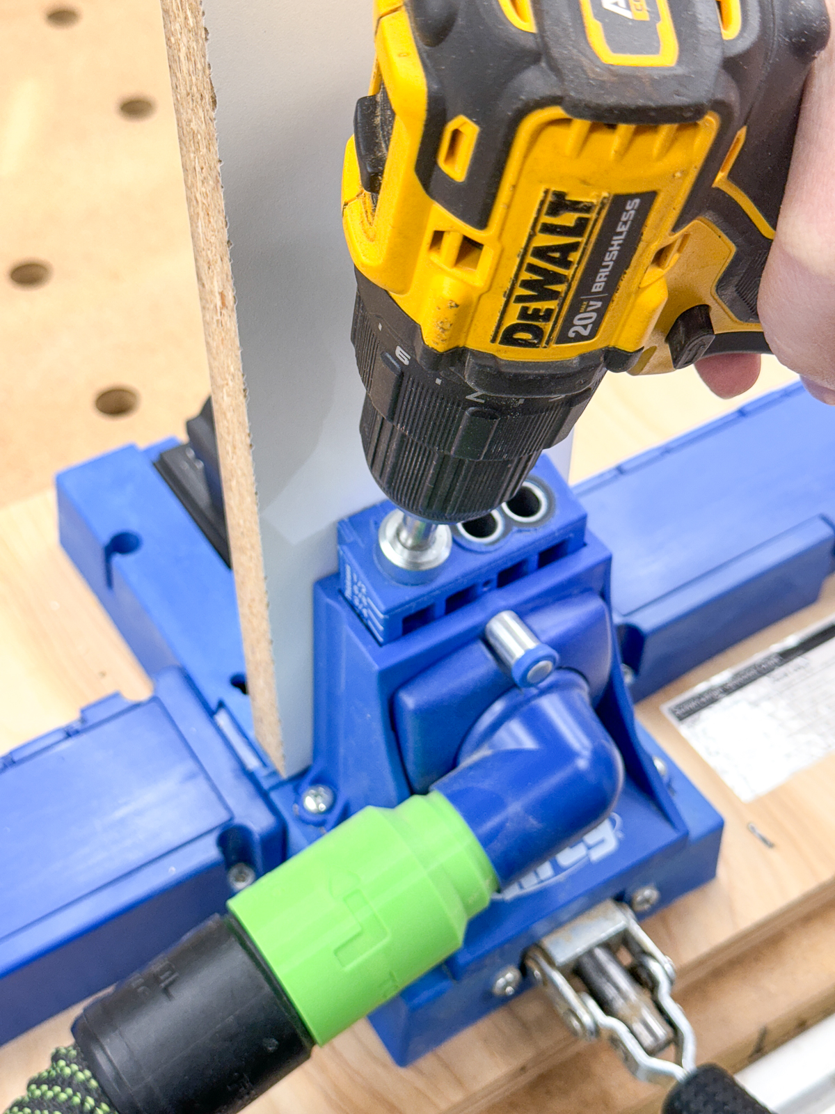 drilling pocket holes in the ends of the stretcher for the DIY craft cabinet