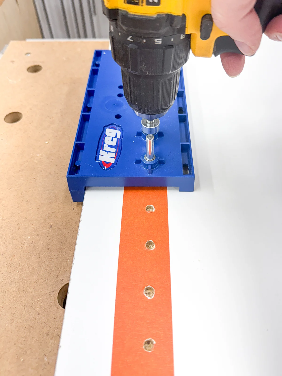 drilling shelf pin holes on the inside of the craft cabinet before assembly