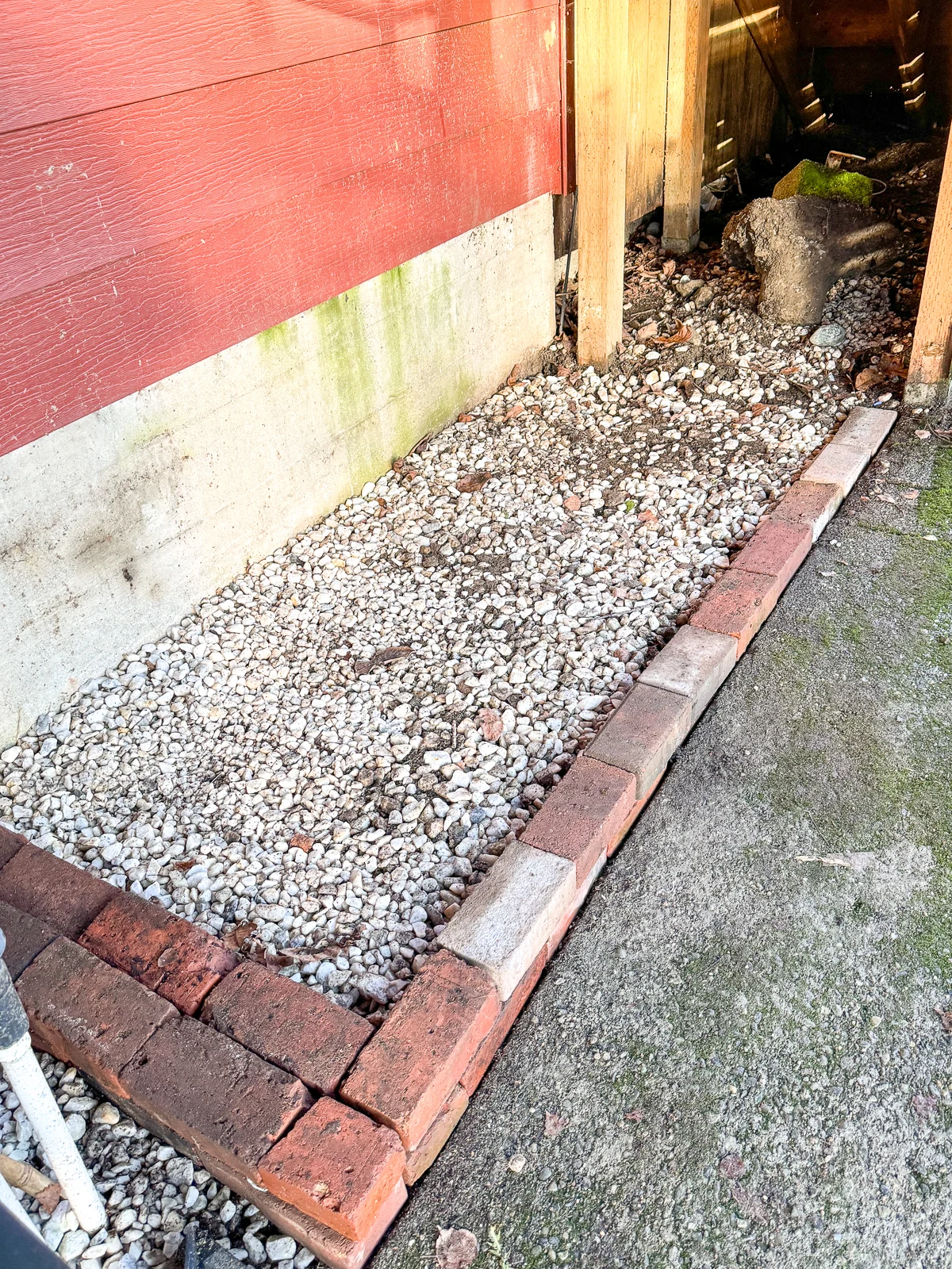 base for bike shed made with bricks, with concrete post footer under the stairs