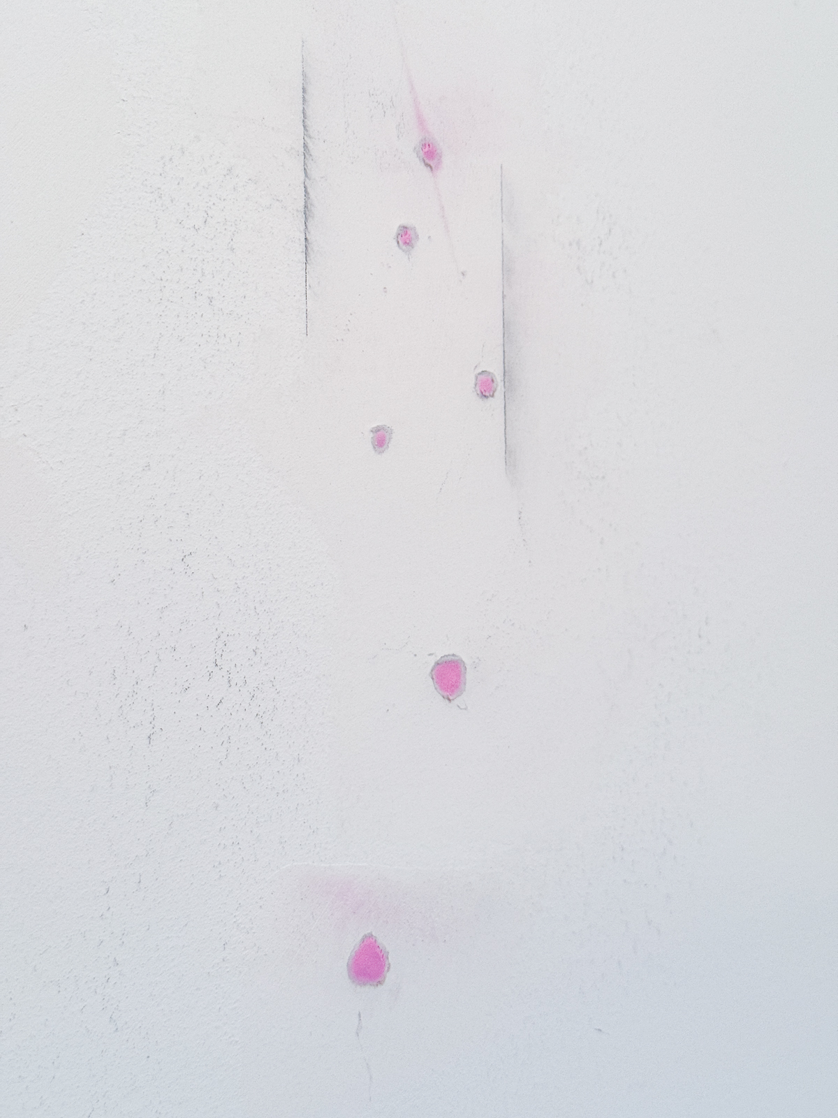 drywall anchor holes filled with spackle that changes from pink to white when dry