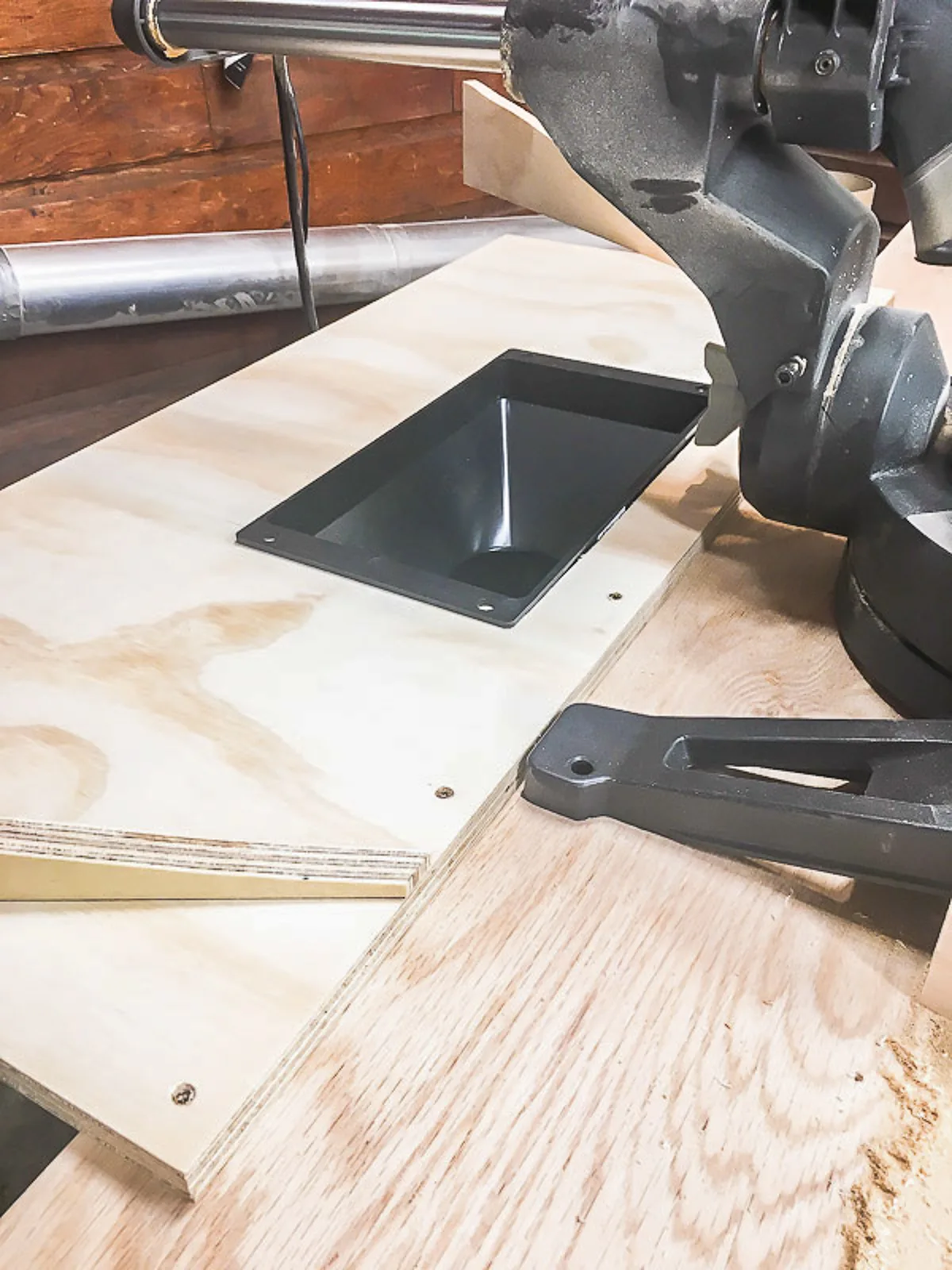 miter saw hood platform attached to stand