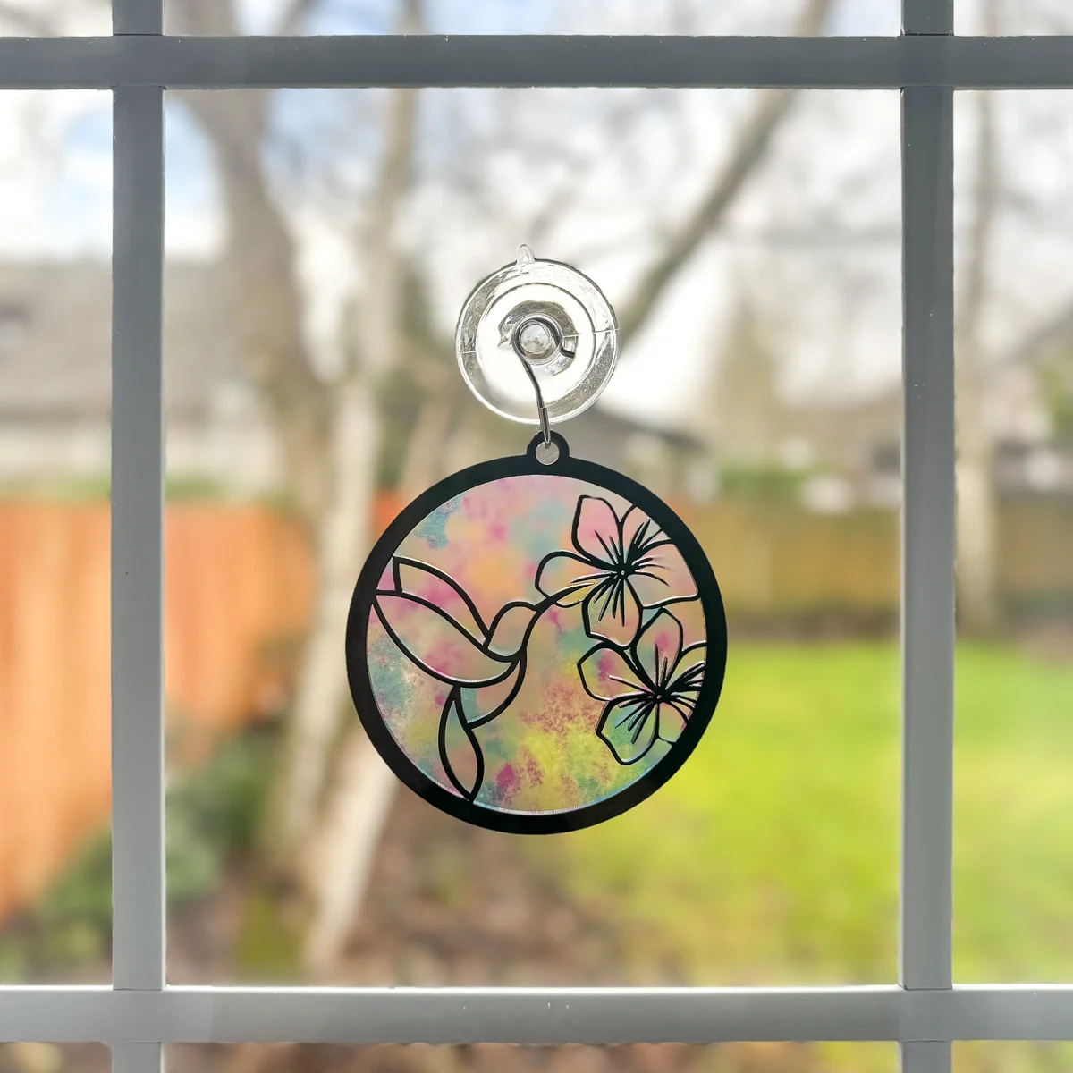 DIY hummingbird suncatcher hanging in the window