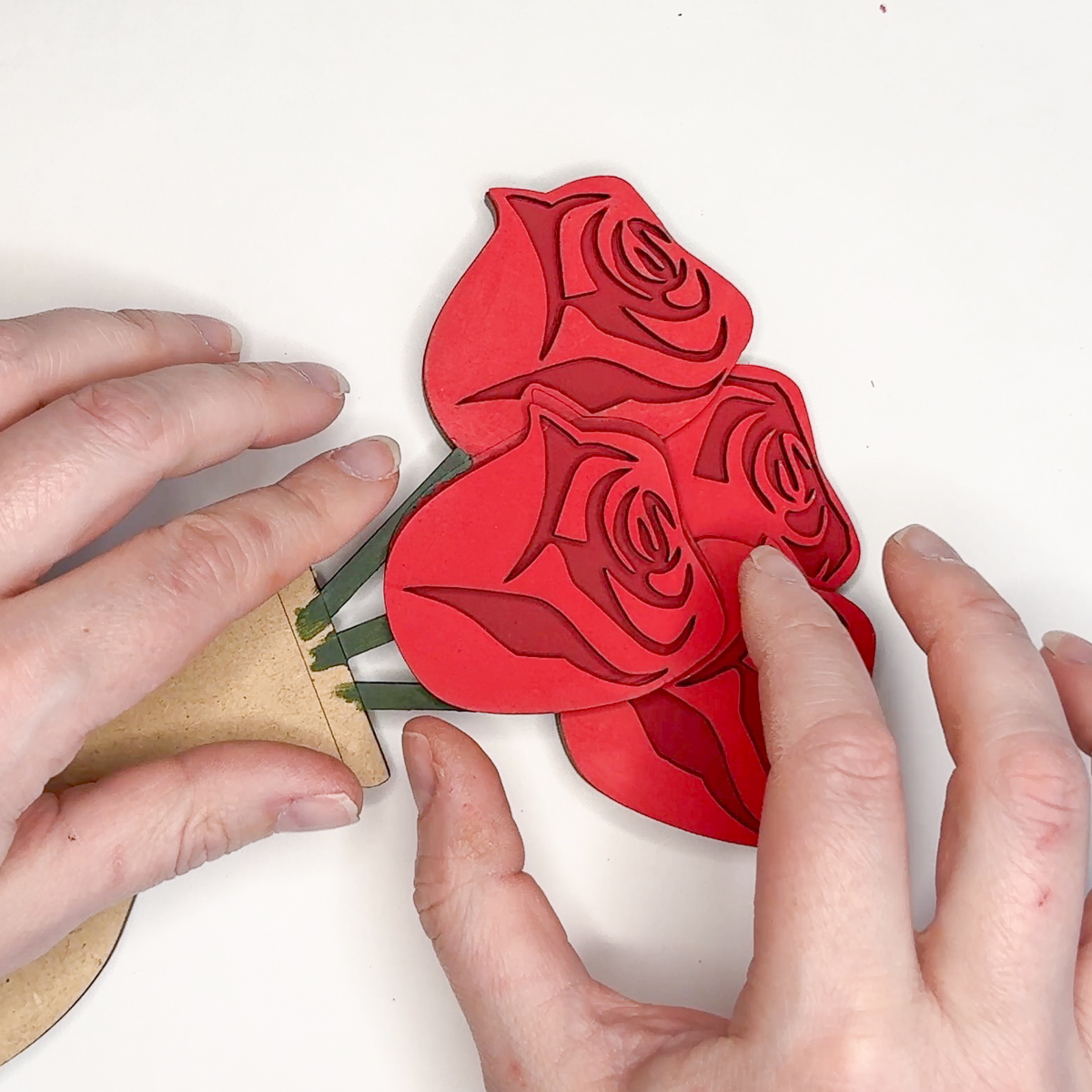 adding the final rose to the bouquet