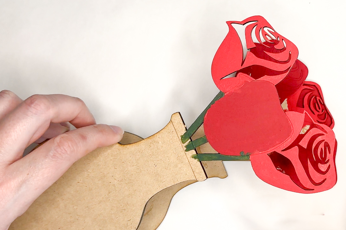 adding the third layer of the laser cut rose bouquet