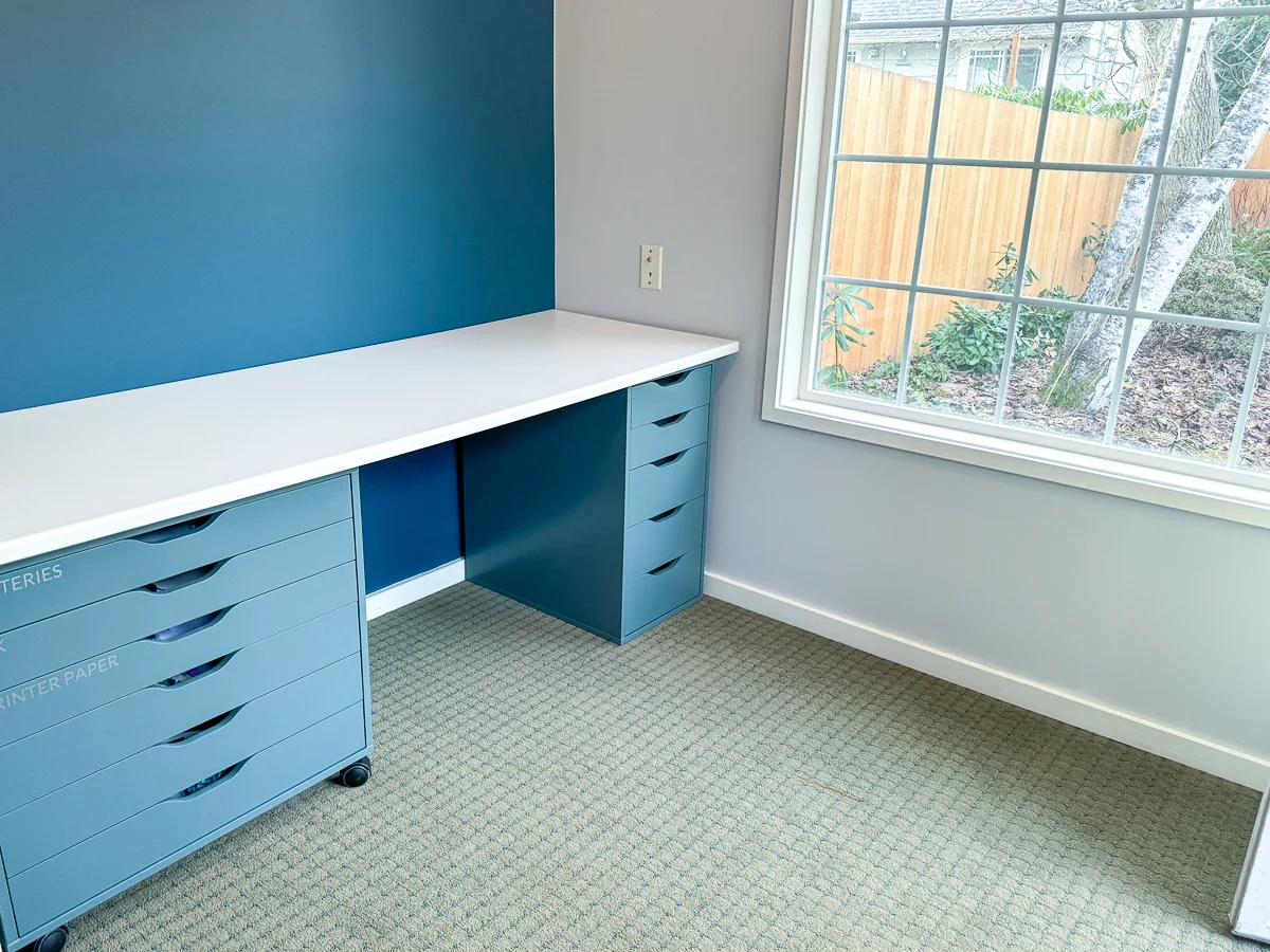 dark blue accent wall behind desk