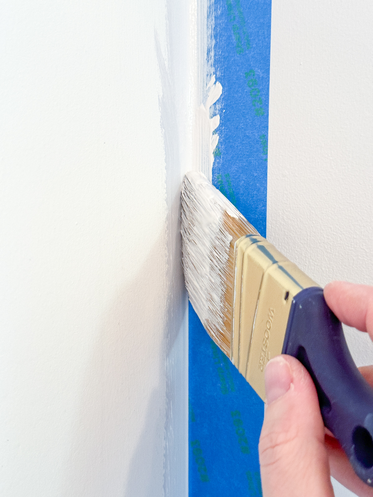 sealing the edge of the painter's tape with the original wall color
