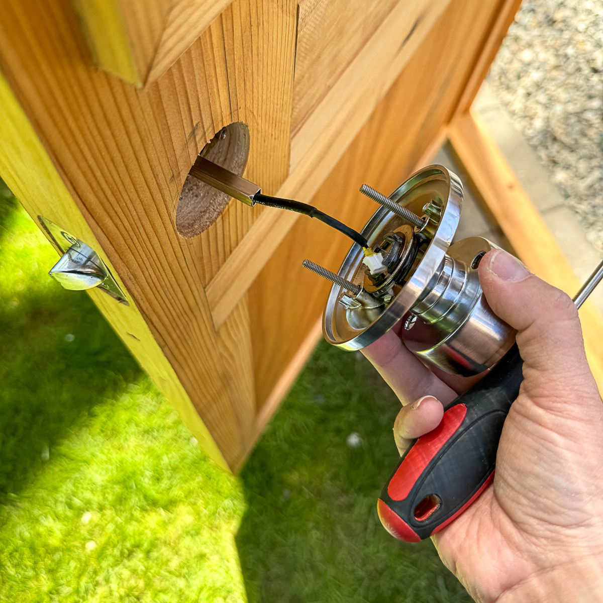 installing the back of the keypad door knob with the wire inserted into center