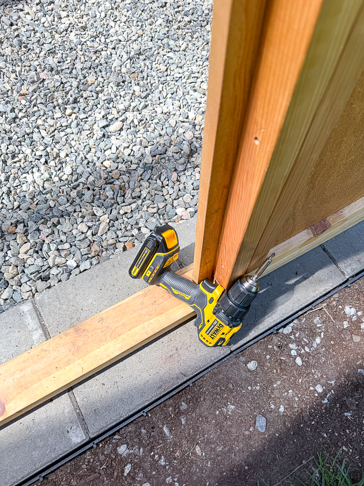 using a cordless drill as a door stop while installing the door knob