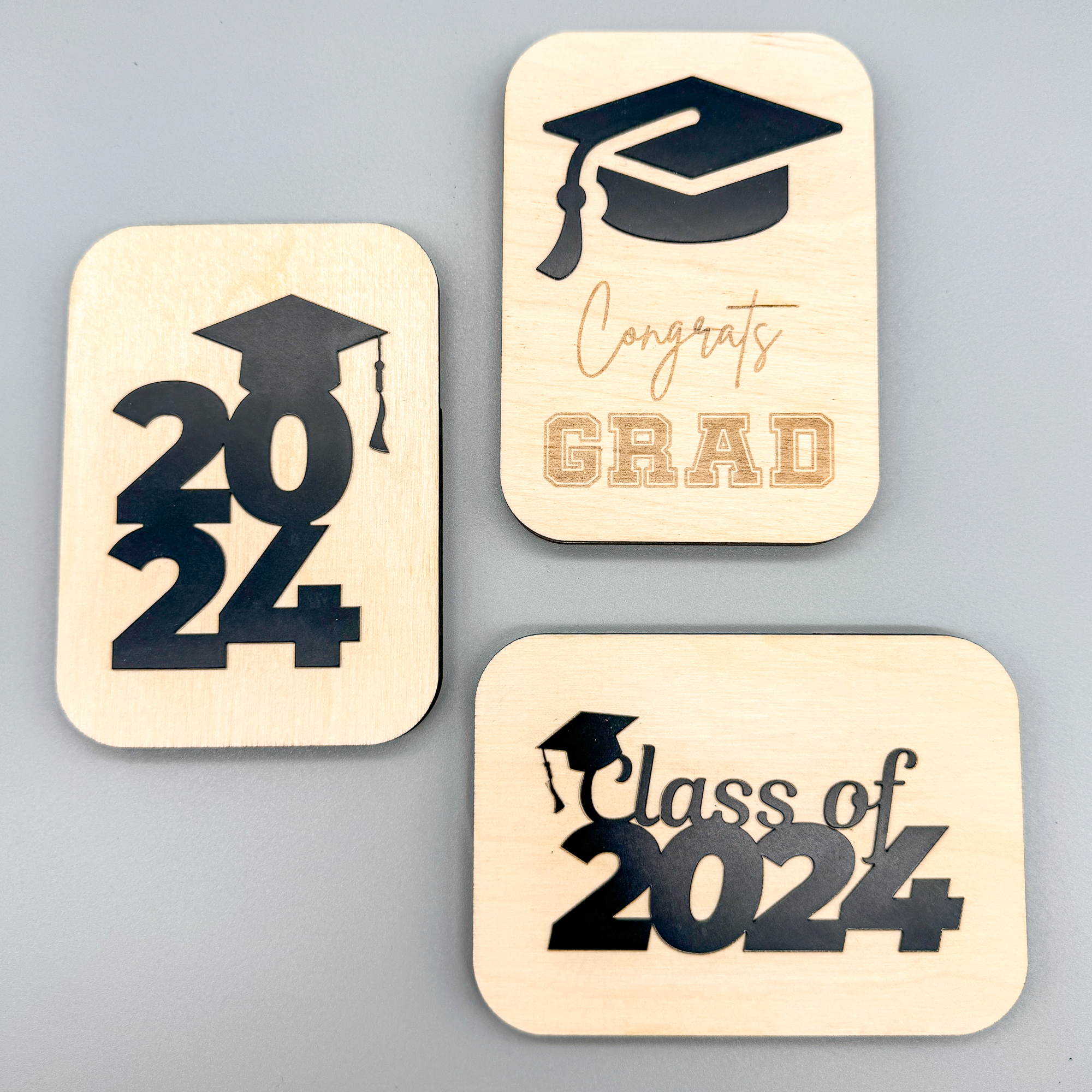 three variations of a laser cut DIY gift card holder for graduation