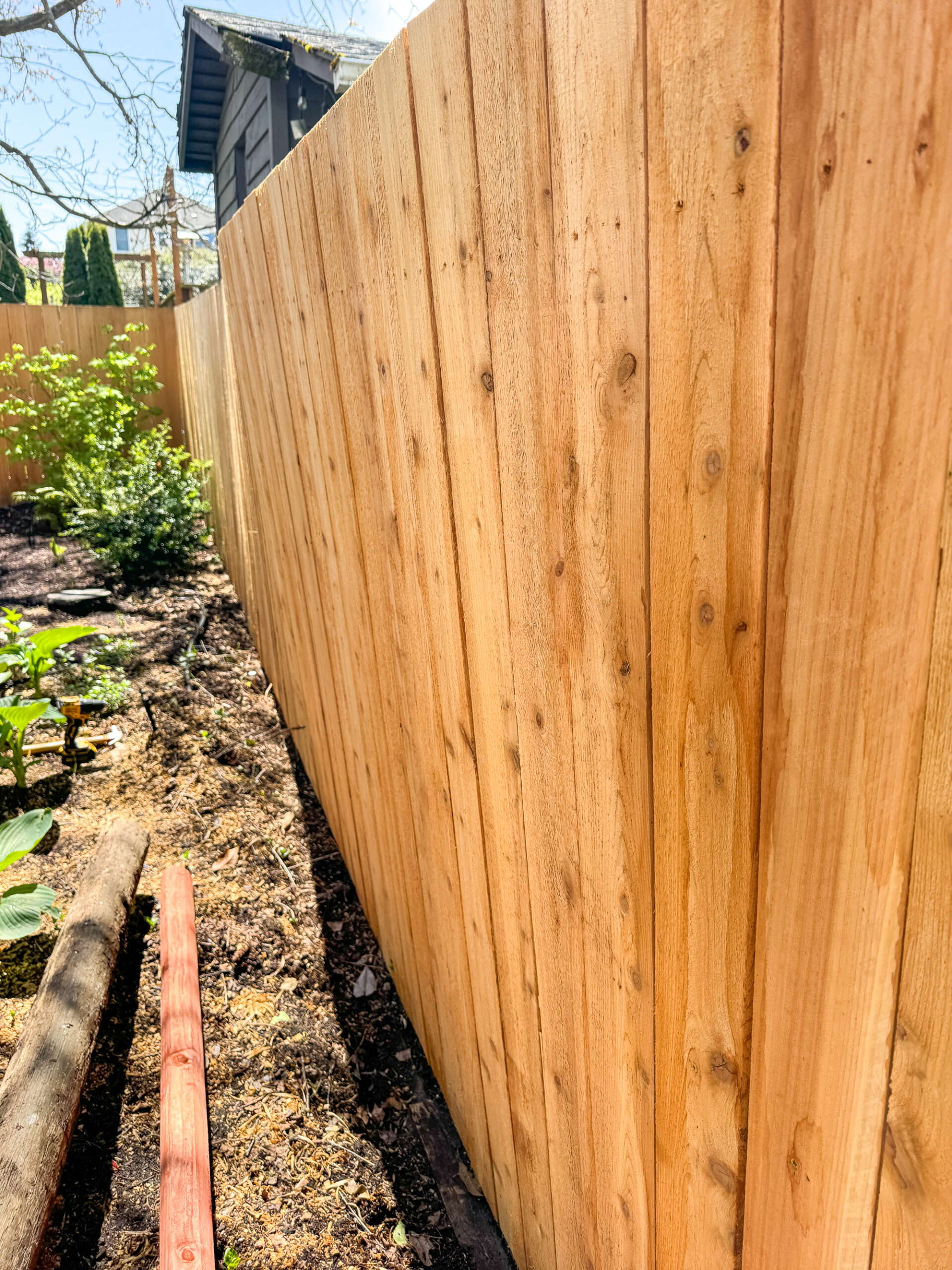 fence leaning into the yard