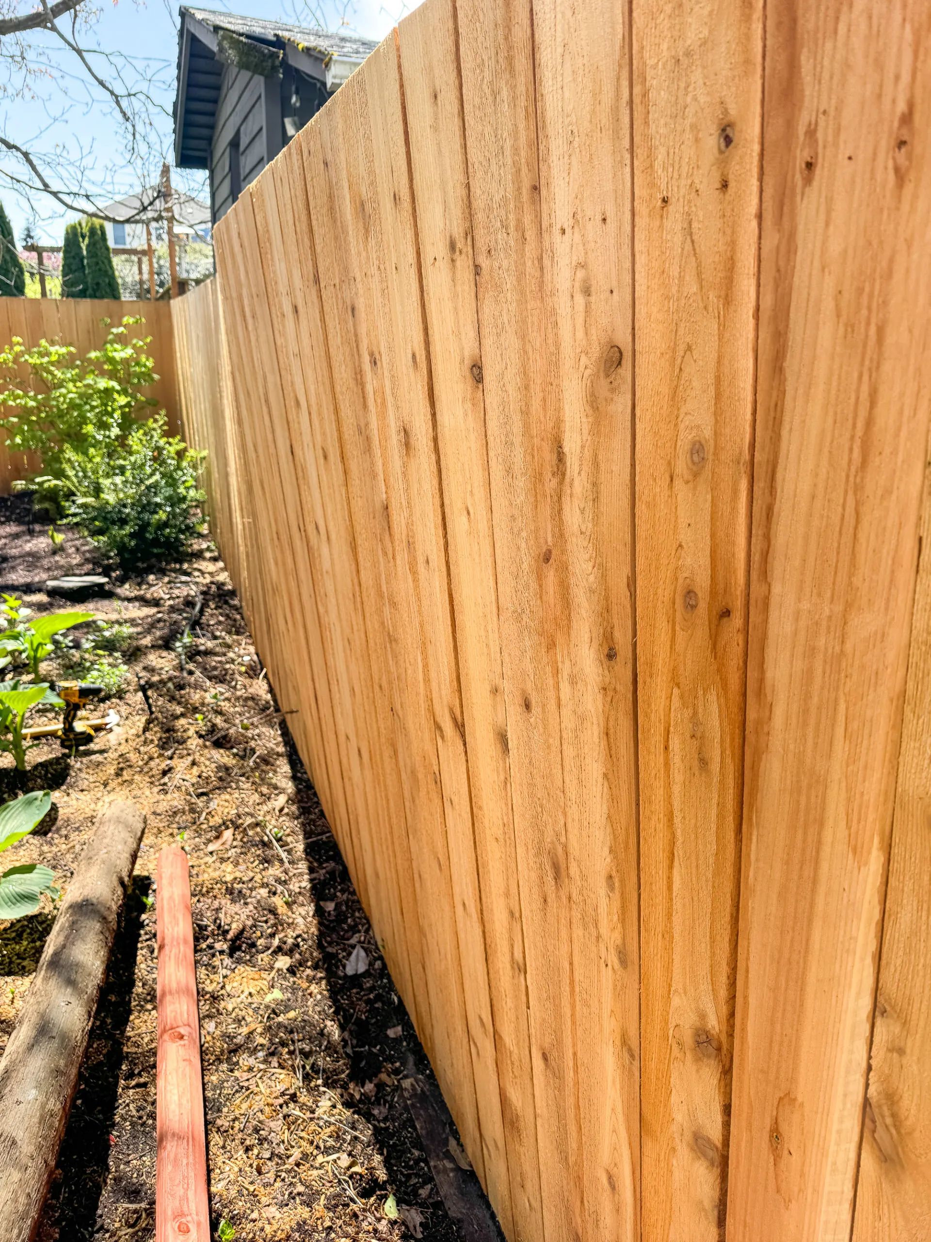 fence leaning into the yard