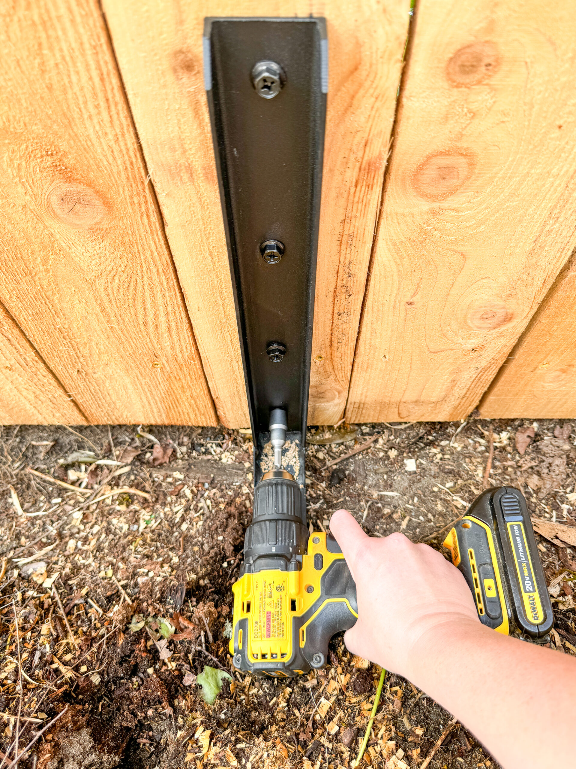 tightening bolts on fence post repair bracket