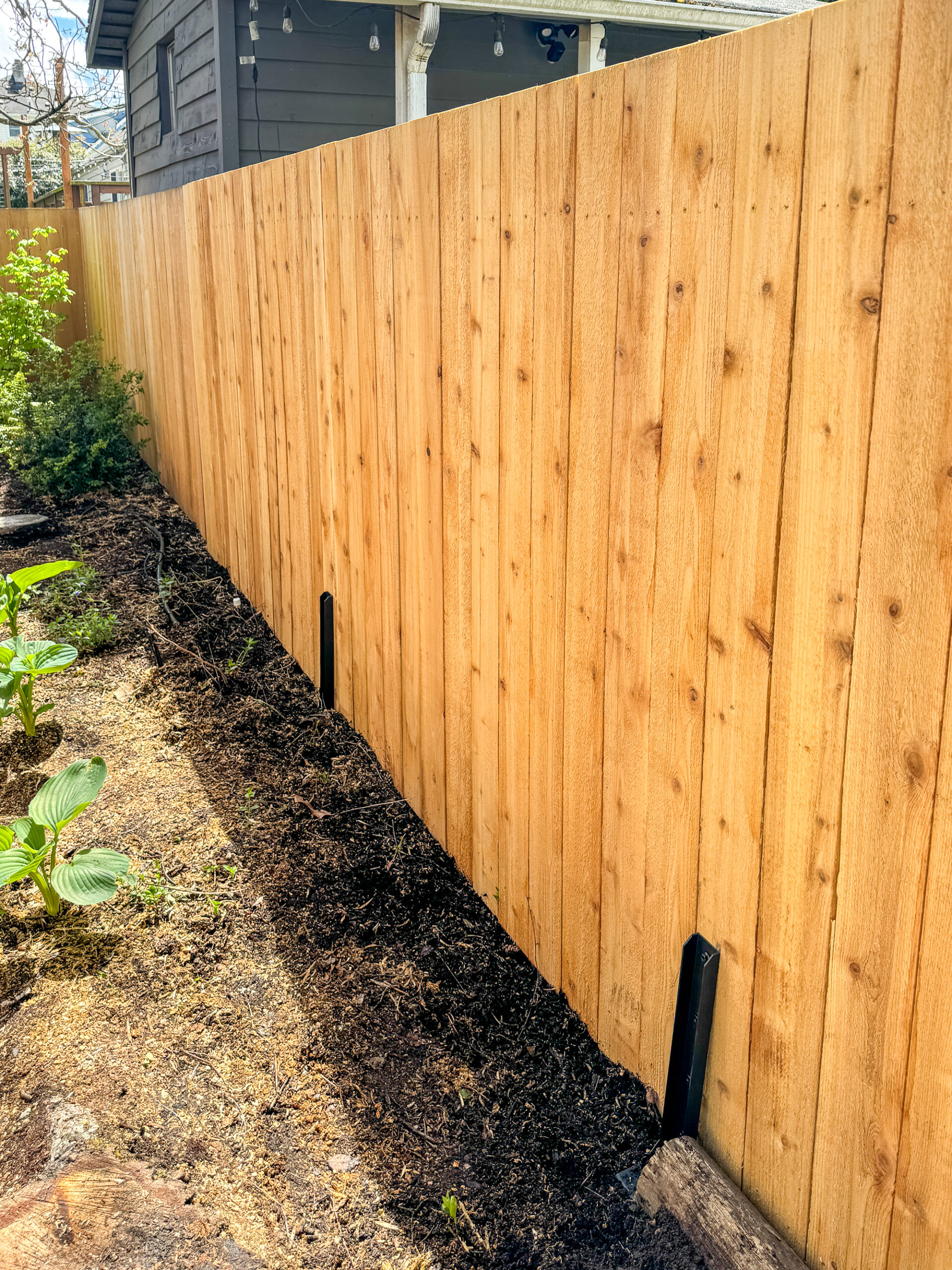 leaning fence fixed with metal brackets